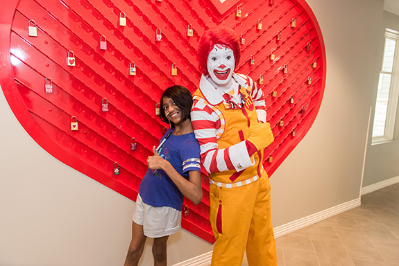 RMHD House guest Swetha Prakash with Ronald McDonald in front of new “lock” installation