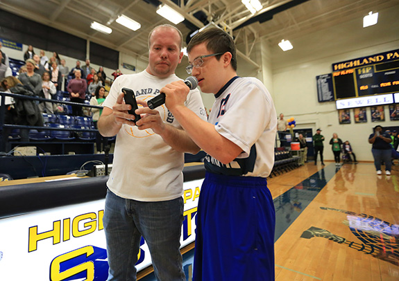 Highland Park ISD Special Olympics Coordinator Tyson Peterson helps a player recite the Special Olympics oath